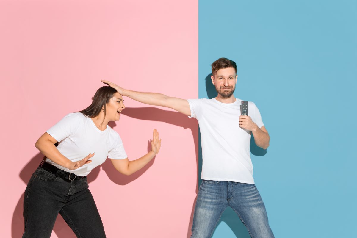 Young emotional man woman pink blue wall