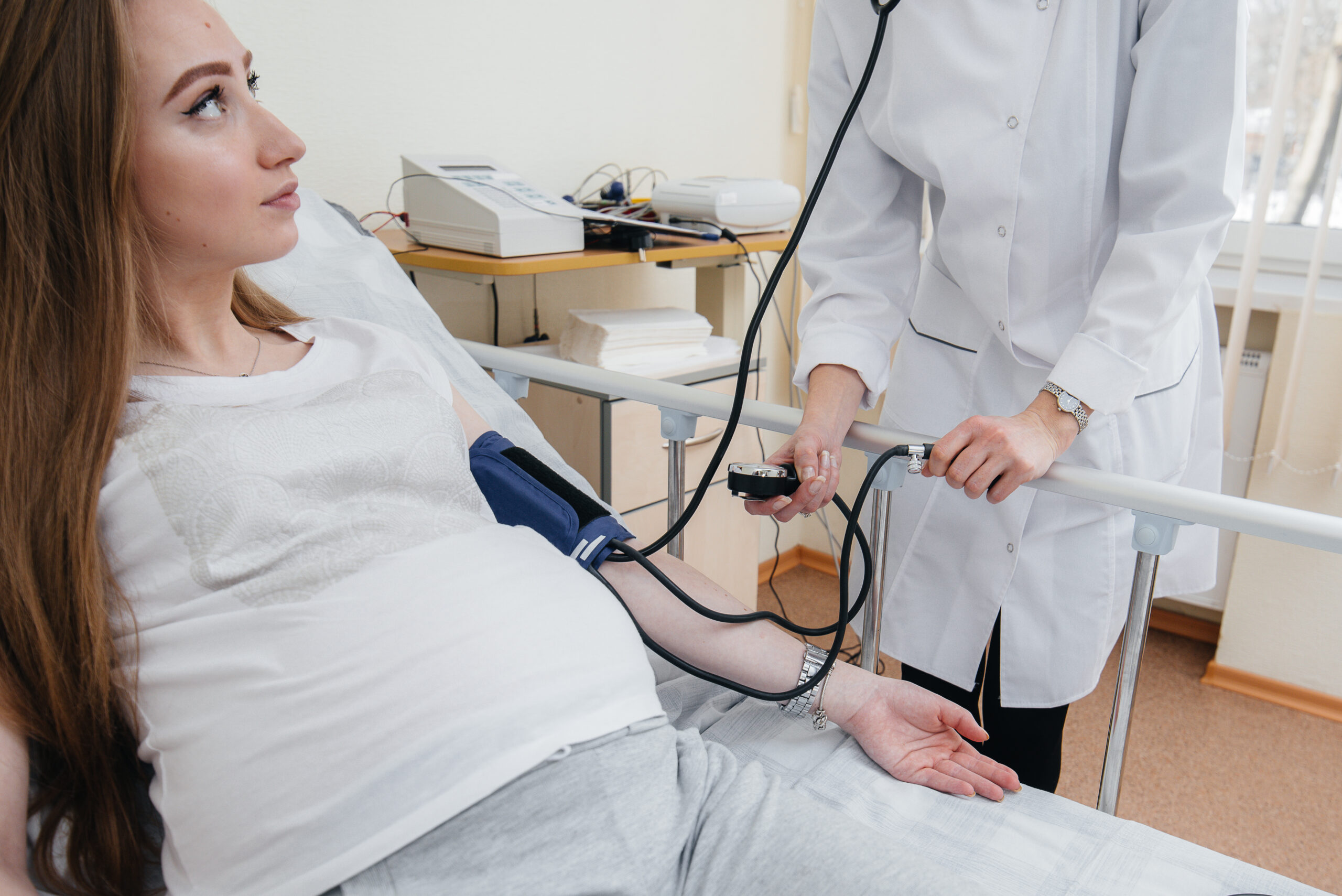 The doctor advises and serves a young pregnant girl in a medical clinic. Medical examination.